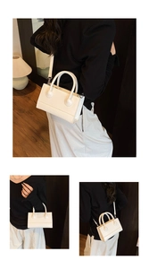Detail view of the elegant white leather handbag with MARGIA logo and adjustable strap