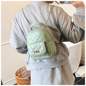 Detail eines hellgrünen gesteppten Eimer-Rucksacks mit Kettenriemen und Metalldrehverschluss
