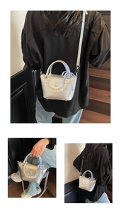 Detail view of silver mini shoulder bag with lace trim and blue checkered bow accessory