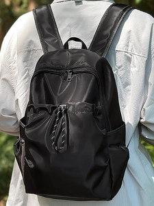 Waterproof lightweight black travel backpack with multiple pockets and drawstring design