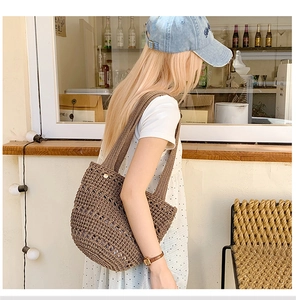 Close-up of a brown hollow crochet shoulder bag showing woven texture and strap details
