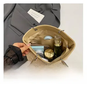 Internal view of beige woven tote bag showing spacious lining and multiple pockets