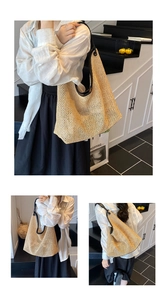 Detail shot of the large woven straw tote bag with black leather straps and piping trim