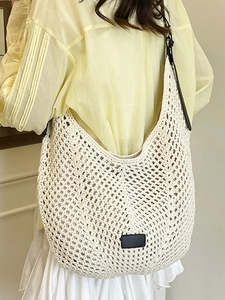 Large capacity woven tote bag in cream white with black leather shoulder straps and patch