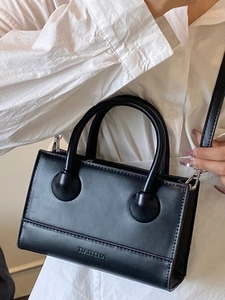 Elegant black glossy leather handbag with dual handles and silver metallic hardware detailing