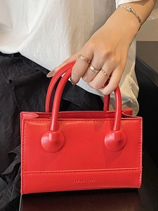 Elegant bright red mini handbag with unique sphere handle detail and crossbody strap