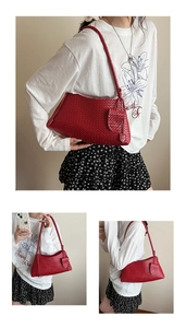 Detailed view of red hand-woven leather texture and tassel on a retro shoulder bag