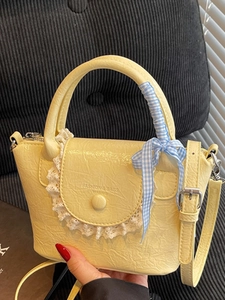 Elegant light yellow mini crossbody bag with lace trim and ribbon handle decoration