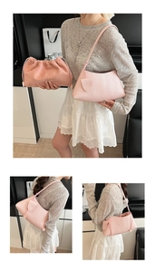 Detail of woven light pink shoulder bag with knot handle and soft drawstring cloud pouch