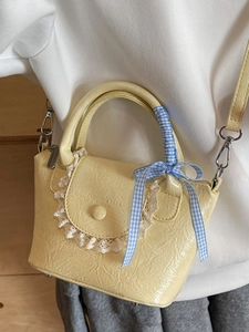 Elegant yellow textured shoulder bag with lace trim and ribbon handle for women