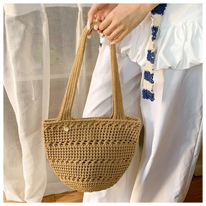 Detail of hand-woven crochet tote bag in khaki with comfortable shoulder straps for women