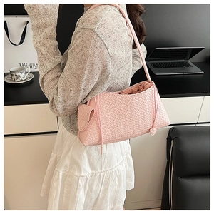 Detailed pink woven underarm bag with drawstring inner bag and small side pouch charm
