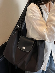 Large black nylon tote bag with leather trim and contrast stitching for women