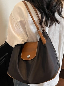 Contrast nylon tote bag with leather trim and silver metal buckle for daily commute