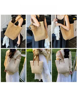 Detail showing the large woven straw tote bag with brown leather straps for vacation use