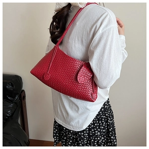 Detail of red woven texture on a French style hobo shoulder bag with sleek straps