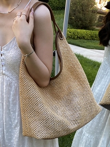Retro woven straw tote bag with brown leather trim for summer beach vacation