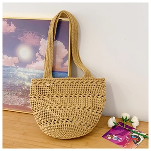 Detailed macro view of handcrafted woven crochet texture on a straw beach tote bag