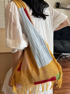 Bohemian knit tote bag with vibrant color-block pattern and fringe tassels detail