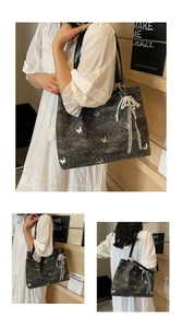 Detail of black tweed tote bag with silver butterfly applique and pearl lace charm