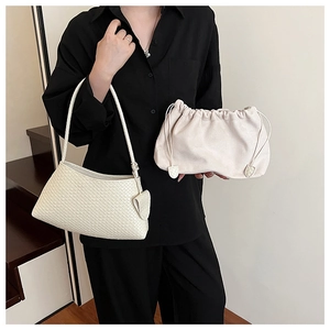 Close-up of white woven shoulder bag and beige drawstring clutch for daily commute