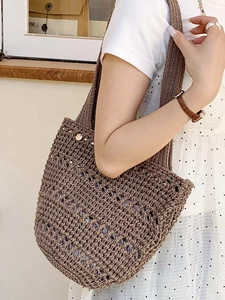 Deep brown hand-woven hollow knit tote bag with elegant wavy texture for summer beach
