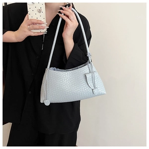 Detail of woven shoulder bag in silver-grey featuring side drawstring knot detail