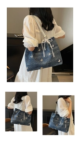 Three-way view of blue denim tote with white butterfly embroidery and lace pearl charms
