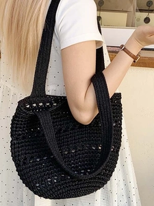Black handmade crochet tote bag with hollow knit pattern for summer beach vacations