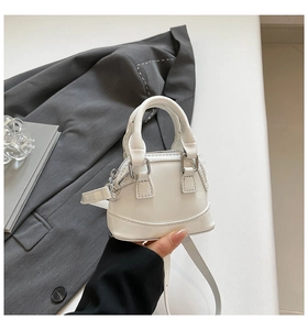 Mini white patent leather shell bag with high gloss finish and metallic zipper detail