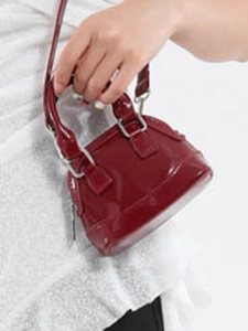 Mini red patent leather dome bag with glossy shell shape and silver strap hardware
