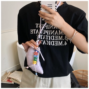 Mirror selfie showing lilac croissant mini crossbody bag with colorful sun letter beads