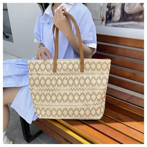 Detailed texture of hollow woven paper rope tote bag with brown geometric patterns