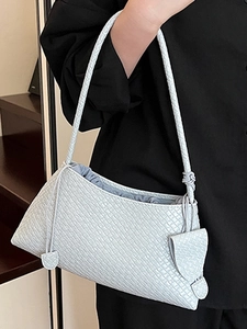 Elegant light blue woven underarm bag with minimalist braided leather and drawstring closure