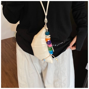 Detail of cream croissant mini bag with colorful LOVE letter beads on a lanyard