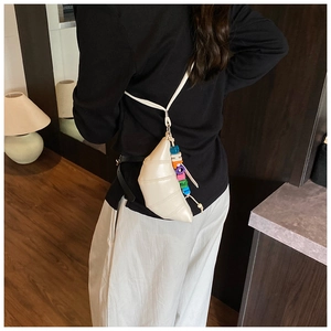 Detail of white croissant crossbody bag with colorful HOPE letter charm and sleek PU leather