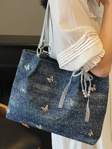 Polka dot denim shoulder bag with silver butterfly metal charms and lace bow accessories