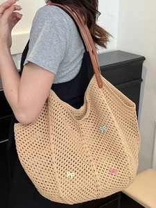 Beige hollow crochet tote bag with colorful bows and brown faux leather straps