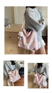 Detailed view of pink quilted tote bag with floral embroidery and cloud plush charm