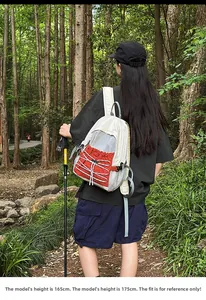 Hiking backpack with color stitching and elastic cords in forest outdoor setting