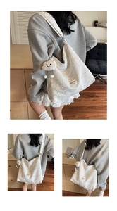Detail of white quilted canvas tote with colorful embroidery and plush cloud charm