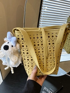 Large capacity hollow design bucket bag in yellow PU leather with plush dog charm