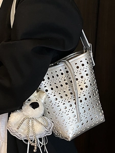 Silver hollow out bucket bag with laser cut pattern and cute plush bear charm