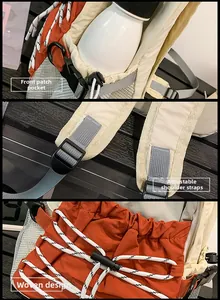 Detail of waterproof outdoor backpack with orange mesh pocket and adjustable padded straps