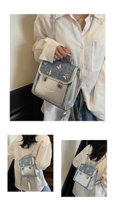 Detail of silver butterfly hardware and blue sequin flap on a mini backpack