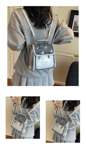 Detail of silver butterfly buckle and metallic blue texture on stylish mini backpack