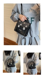 Detail showing tweed leather拼接 texture and metal butterfly ornament on a black bag