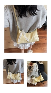 Detail of yellow glossy leather shoulder bag featuring a pearl bow and lace accent