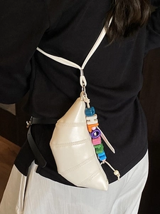 Minimalist beige croissant crossbody bag with leather pleats and letter bead charm