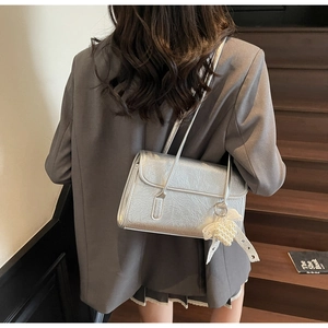 Detail of silver metallic wrinkled texture shoulder bag with pearl heart charm
